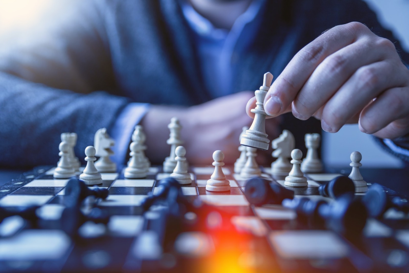 man playing chess planning next strategic move