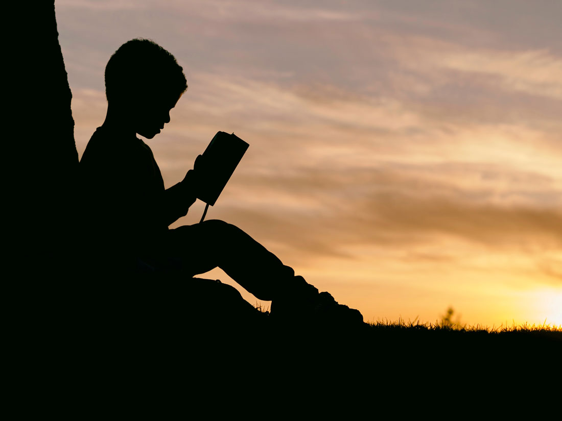 kid reading book to expand his mind